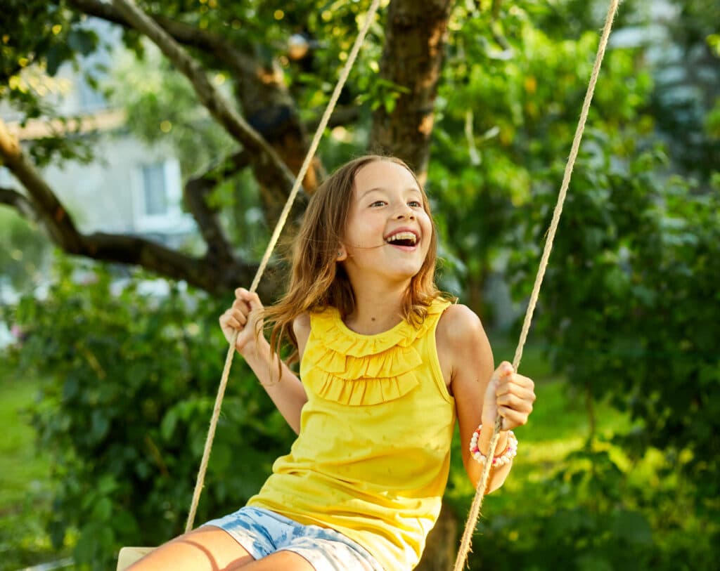 happy barefoot laughing child girl swinging on a s 2023 02 21 03 48 42 utc scaled e1698689531213