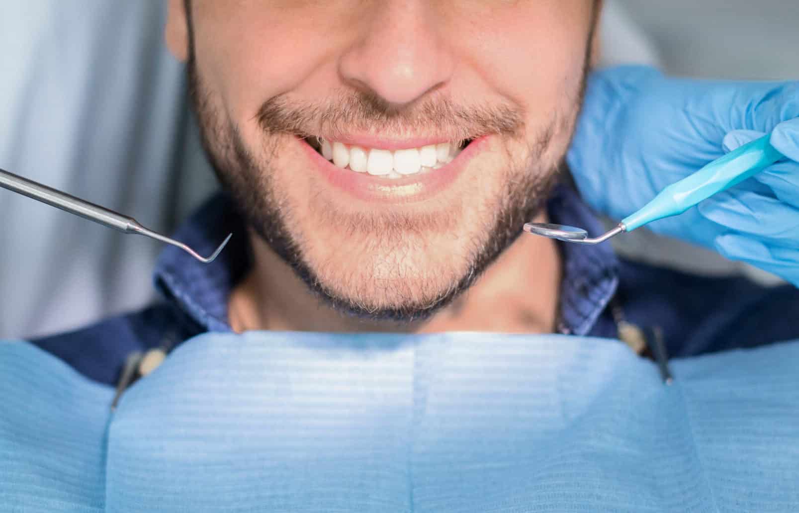 unrecognizable male patient having teeth whitening 2022 12 16 08 24 15 utc scaled e1698682594247